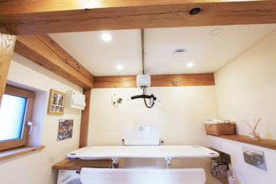 OT200-Compact-Ceiling-Hoist-on-Straight-Track-over-Fixed-Height-Changing-Table-400x267